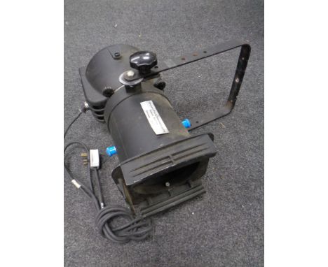 A theatre light on telescopic stand together with three drum kit stands. 
