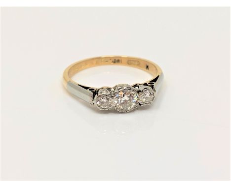 An 18ct gold three stone diamond ring, size M CONDITION REPORT: 2.5g