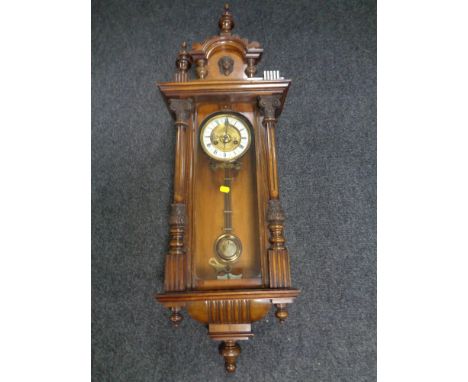 An Edwardian eight day wall clock with brass and enamelled dial. 