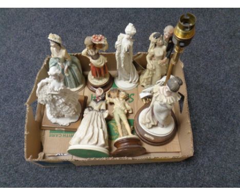 A box of assorted contemporary figurines, together with a figural table lamp. 