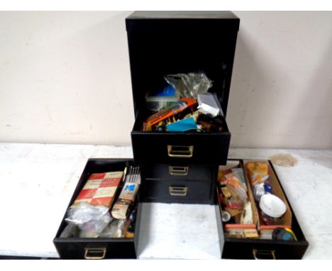 A metal six drawer index chest containing a small quantity of hand tools and hard ware. 
