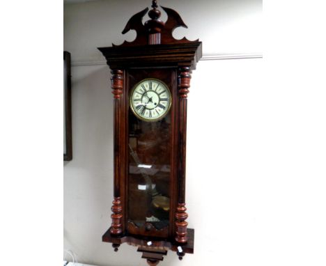 An Edwardian Vienna style wall clock with brass and enamelled dial. 