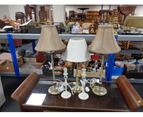 A brass table lamp with shade together with two further pairs of table lamps, one with shades. 