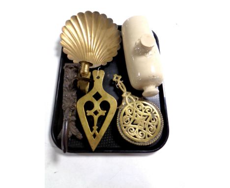 A tray of stoneware hot water bottle, antique metal wares to include brass trivets, brass Art Deco candle sconce, 19th centur