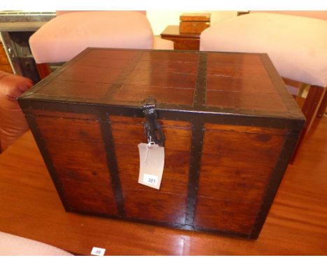 A 19th century stained pine and metal bound trunk with twin handles 