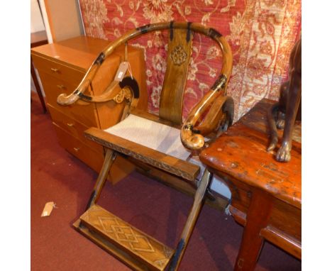 A Chinese folding campaign elm chair having carved panels and ebonised bronze mounts