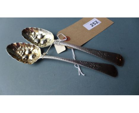 A George III hallmarked silver converted berry spoon with a similar 