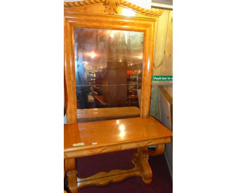 A Beidermeier satinwood console table with large mirrored back in a moulded frame and raised on scrolling supports and shaped