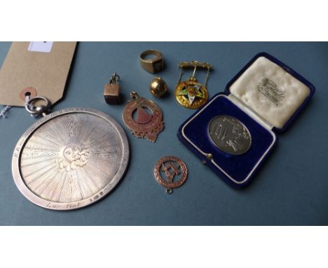 A collection of Masonic items featuring a number of 9ct gold items, including a ring with compass design, a metamorphic globe