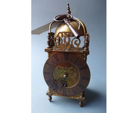 A Brass lantern clock, having a circular dial with Roman numerals, the movement by astral of Coventry 