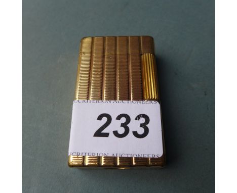 An S J Dupont gold plated lighter with engine turned detail 