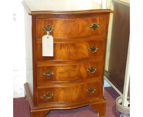 A mahogany serpentine fronted chest fitted four drawers with brass handles on bracket feet