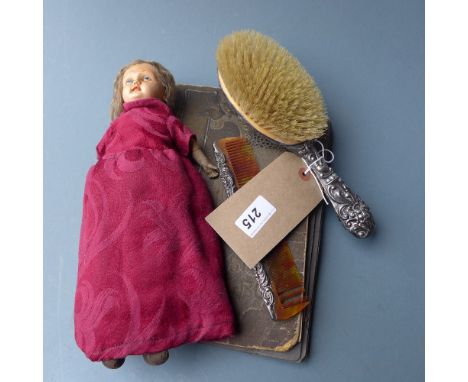 A photo album containing a quantity of postcards, photos and cigarette cards, an antique doll, a hallmarked silver dressing t