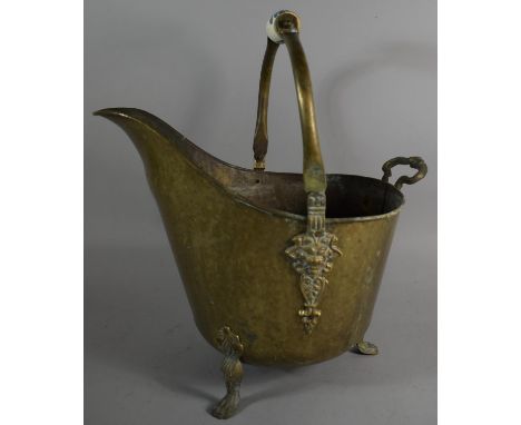 A Reproduction Beaten Brass Helmet Shaped Coal Scuttle with Ceramic Handle 