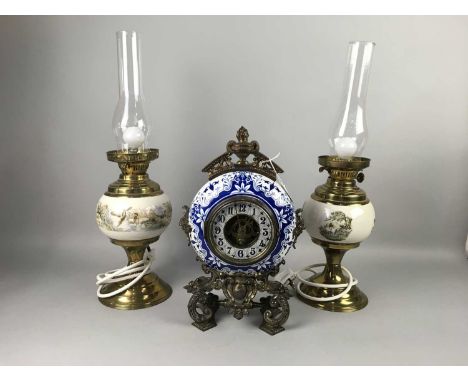 CERAMIC AND GILT METAL MANTEL CLOCK,decorated in blue and white, 38cm high, along with a pair of table lamps modelled in the 