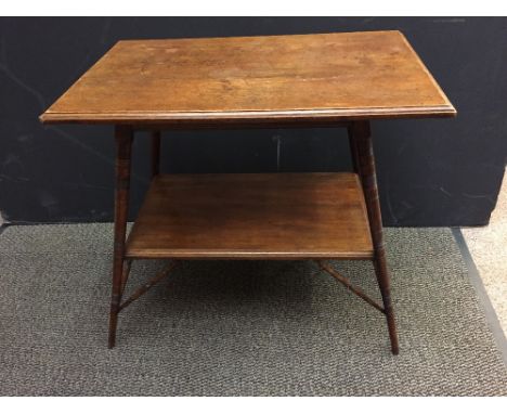 An Aesthetic style oak centre table in the manner of E. W. Godwin, the rectangular top on four splayed ring-turned legs unite