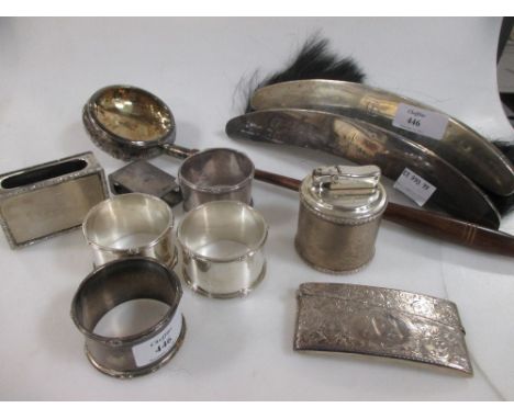 A Victorian card case of curved outline, four numbered napkin rings, a toddy ladle, a silver cased table lighter, a silver to