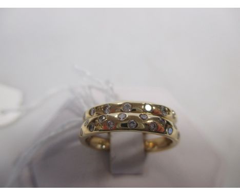 Two 18ct diamond eternity rings, the first a 3.4mm wide band set with spaced out small round brilliant cut diamonds, hallmark