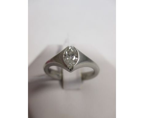 A marquise diamond and platinum ring, estimated approx. 0.58cts, in a rubover setting to broad slightly tapering band of sati