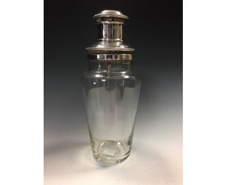 An Art Deco style chrome and glass cocktail shaker, the tapering cylindrical glass body with cromed cover 26cm (10in)  