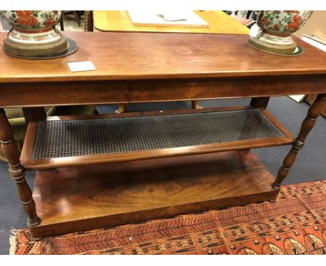 A Mid 19th century mahogany three tier buffet with caned second shelf, on turned column legs, 142cm h x 86cm w x 45d  