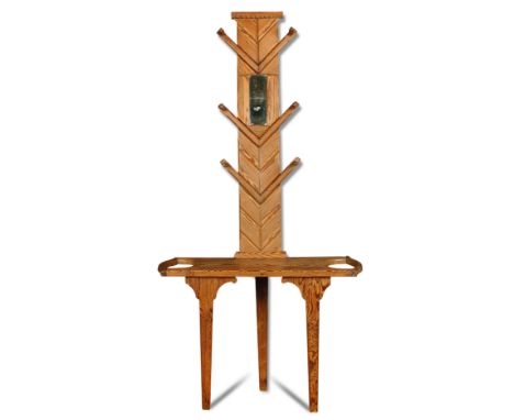 A pitch pine hall stand,the top with central rectangular mirror and six pegs on chevron supports, the base stick stand to eit