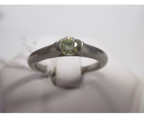 A fancy pale yellow diamond and platinum ring, the round brilliant cut diamond, estimated approx. 0.18cts, in a tension setti