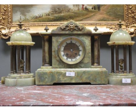 A Victorian onyx cased mantle clock and garniture copula  