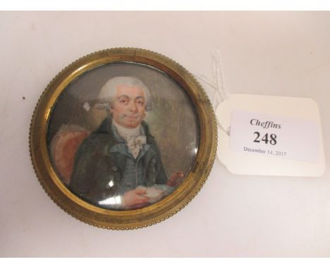 An 18th century Miniature of a Gentleman with a white powdered wig and a green jacket, in a circular engine-turned gilt-metal