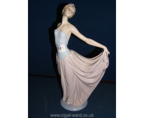 A Lladro figure of a young Dancer with pink and blue dress, marked E-60 to base