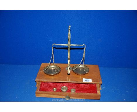 A set of postal Scales with three weights, on wooden base
