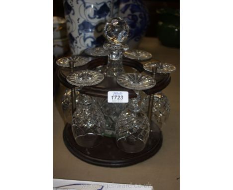 A cut glass Decanter and six Glasses on a wooden stand