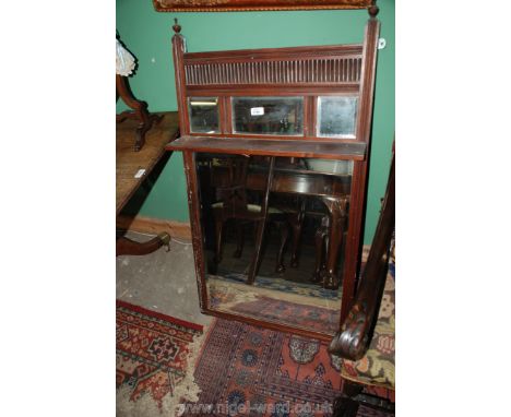 An Edwardian stained Pine Overmantle Mirror, rectangular in form with finials to the outer upright supports, ridged top panel