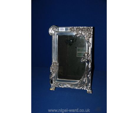 A cast white metal framed table-top Mirror decorated with Art Nouveau style Lady reclining against flowering tree forming a s