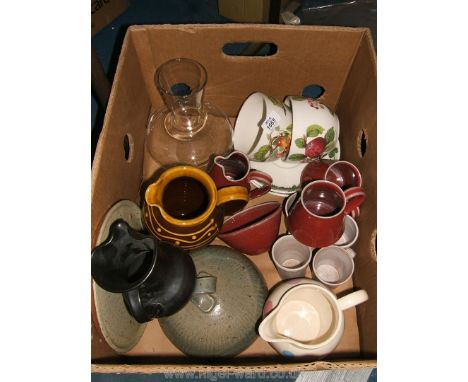 A quantity of china including large Portmeirion cups and saucers, Prinknash jug, Welsh brown jug, pottery cheese dome, red st
