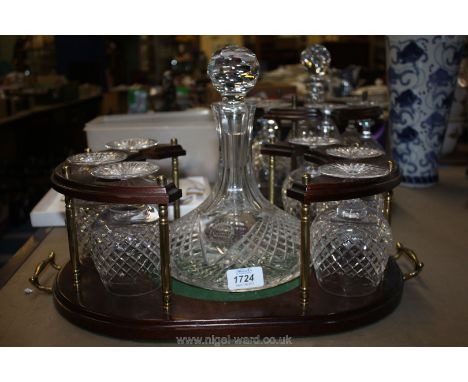A Stuart Crystal Glass ship's Decanter with commemorative motif, six matching brandy Glasses and wooden stand.