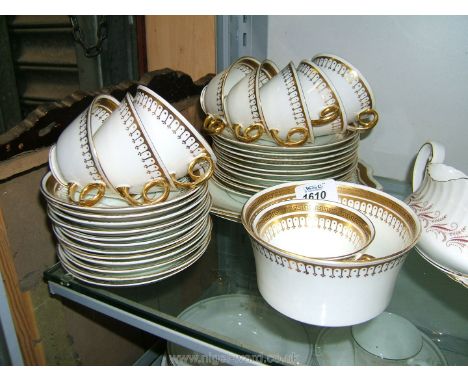 A quantity of Diamond Pottery Teaware including twelve saucers, ten plates, seven cups, two bread and butter plates and a slo