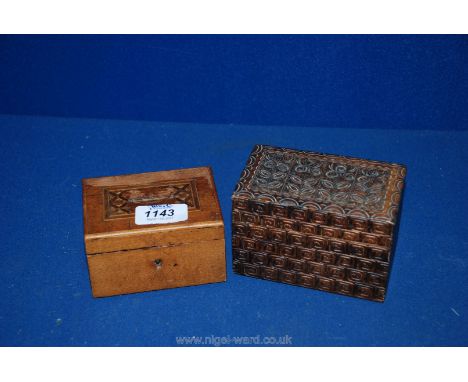 A money box containing Coins and a carved trinket Box