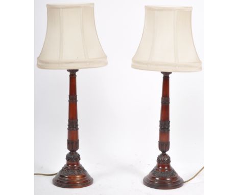 Rochamp Ltd - A matching pair of contemporary carved mahogany table lamp lights having carved stems with acanthus leaf detail