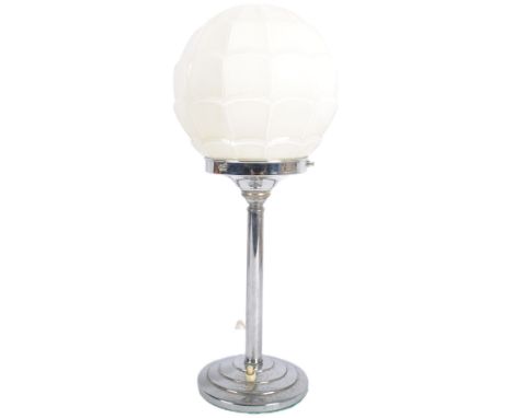 A vintage 20th Century Art Deco table / desk lamp light having a shaped globe opaque glass shade on chrome stem upon a steppe