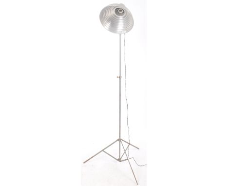 A vintage 20th Century lamp standard having a honeycomb aluminium shade upon a photographic lamp tripod stand. Sold as untest