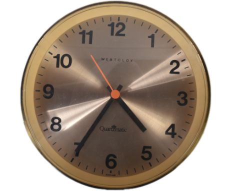 A retro vintage 20th Century Westclox wall clock. Circular form with gilt finish and orange / black hands. Measures approx; 2
