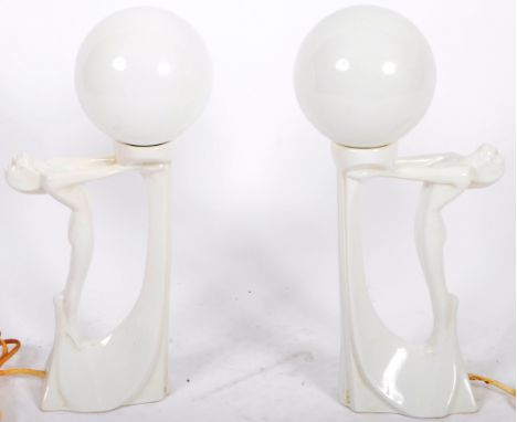 A matching pair of vintage 20th Century Art Deco ceramic table lamp lights with each having opaque glass globe shades support