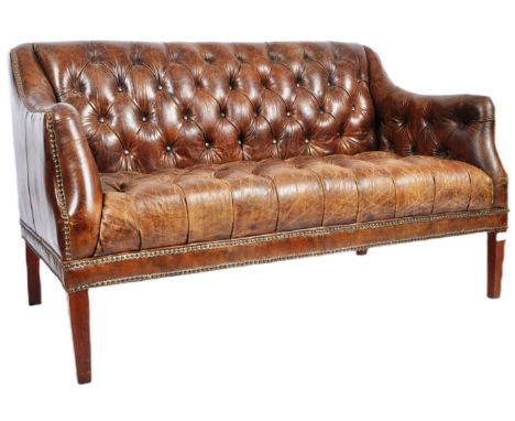 A 20th Century brown leather Chesterfield button backed three seater sofa settee with brass stud detailing with padded seat a