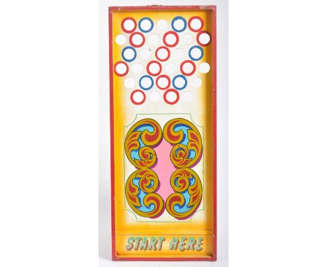 A vintage mid 20th Century fairground / funfair hand painted wooden roller ball game with holes to the top with scrolled pain