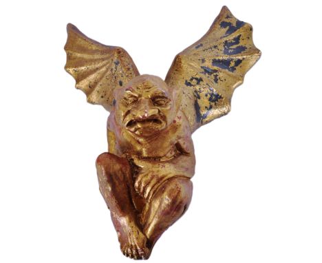 A vintage 20th Century gilt plaster gargoyle wall plaque / figure having wings open moulded in a hunched position. Measures a