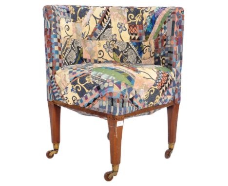 A 19th Century Victorian corner armchair / chair having patterned patchwork upholstery to the curved padded backrest and seat