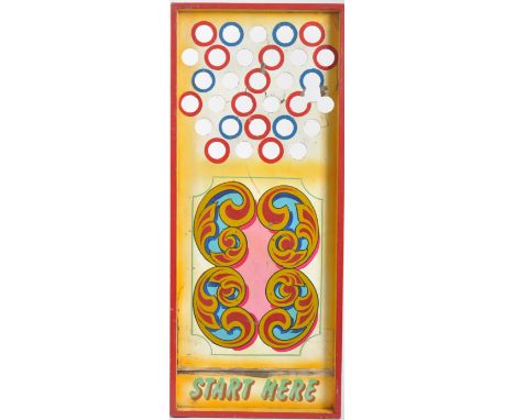 A vintage mid 20th Century fairground / funfair hand painted wooden roller ball game with holes to the top with scrolled pain