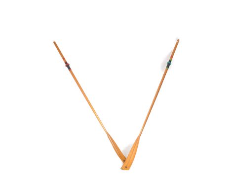 A decorative pair of 20th Century vintage boat rowing oars / paddles of pine construction having original labels for F. Colla