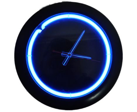 A retro 20th Century 1980s blue neon lit wall clock having a black centre with clear Perspex hands and neon surround. Black f